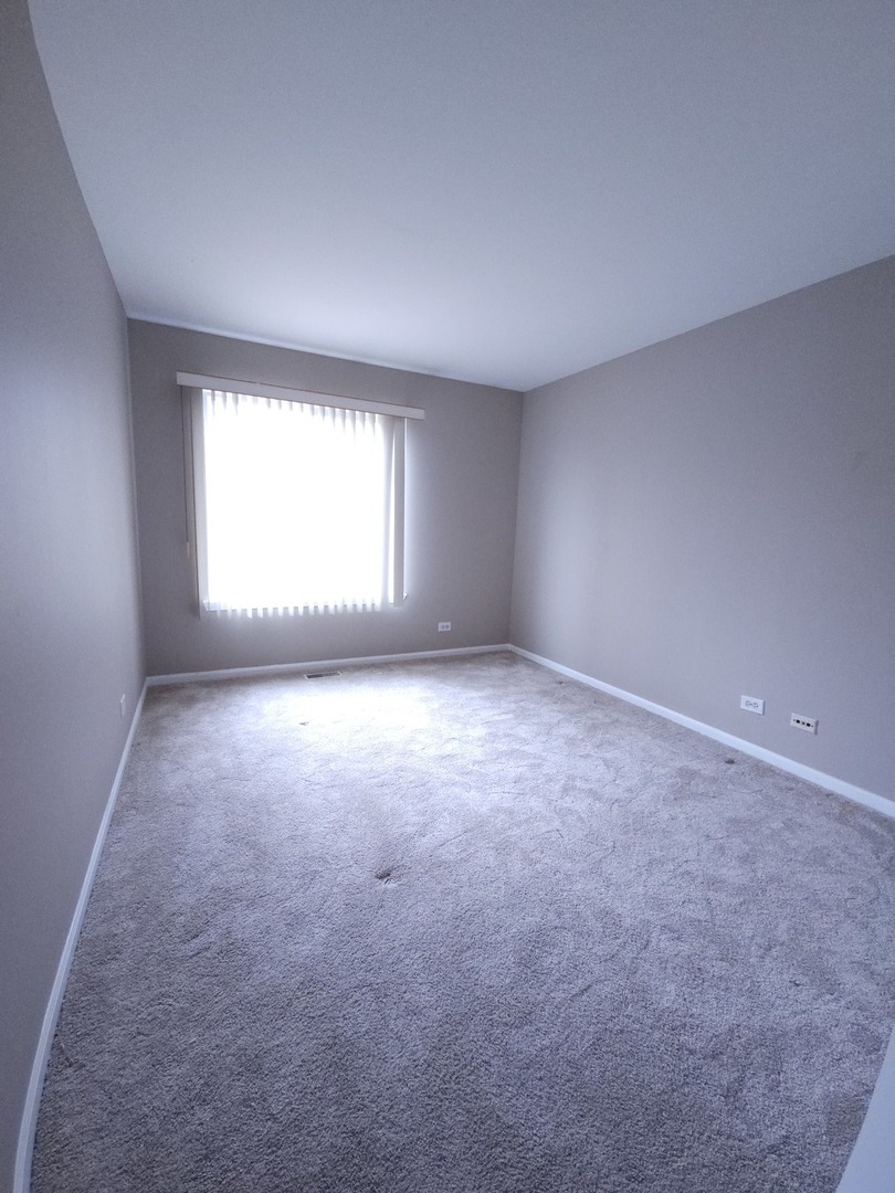 407 Spaulding Road, Unit 407 Bartlett, IL 60103 - Photo 12 of 18 an empty room with a window