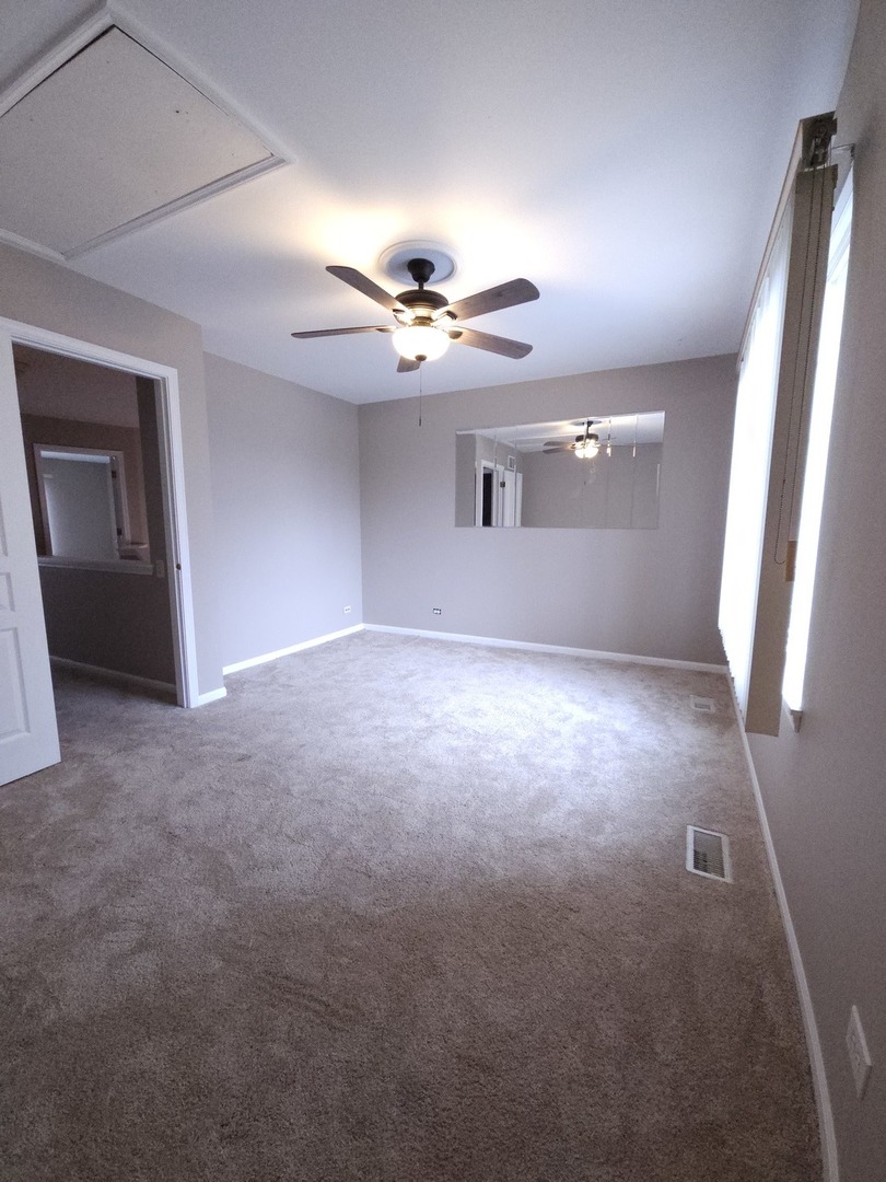 407 Spaulding Road, Unit 407 Bartlett, IL 60103 - Photo 14 of 18 wooden floor in an empty room with a window