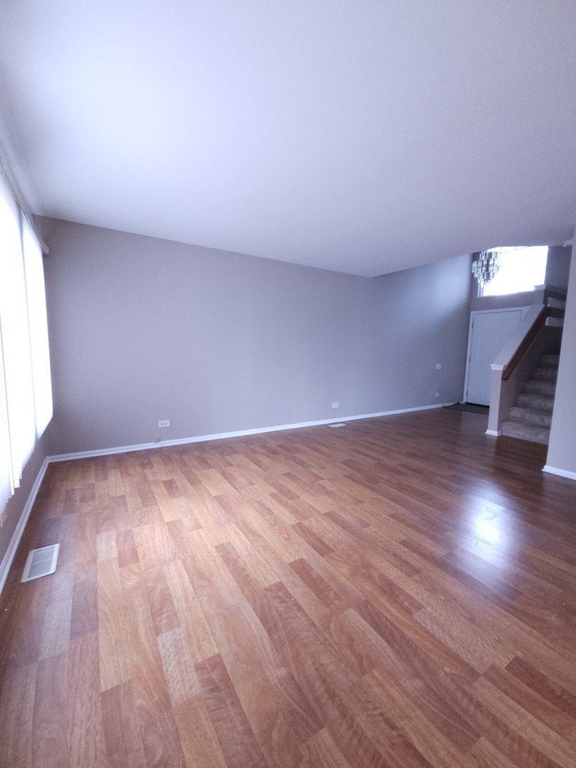 407 Spaulding Road, Unit 407 Bartlett, IL 60103 - Photo 4 of 18 a view of empty room with wooden floor