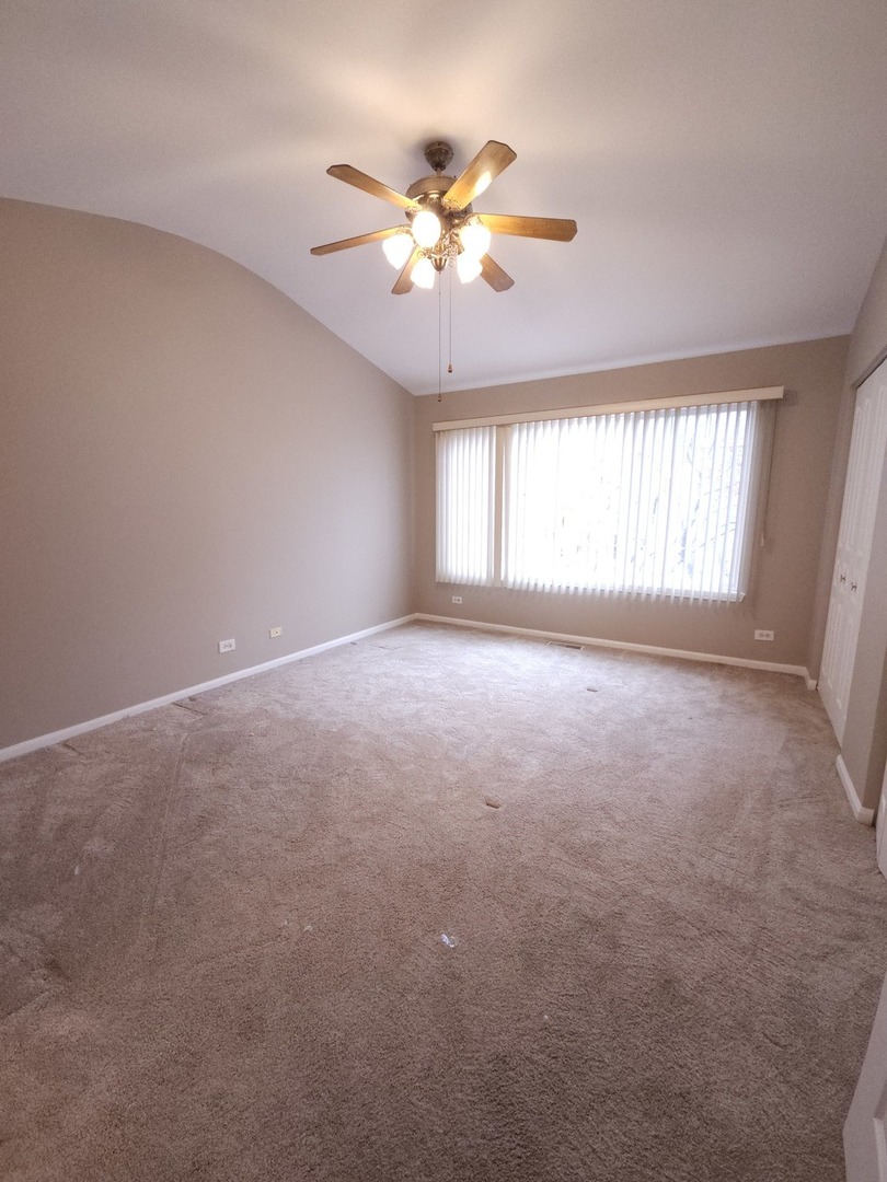 407 Spaulding Road, Unit 407 Bartlett, IL 60103 - Photo 8 of 18 a view of an empty room with a window