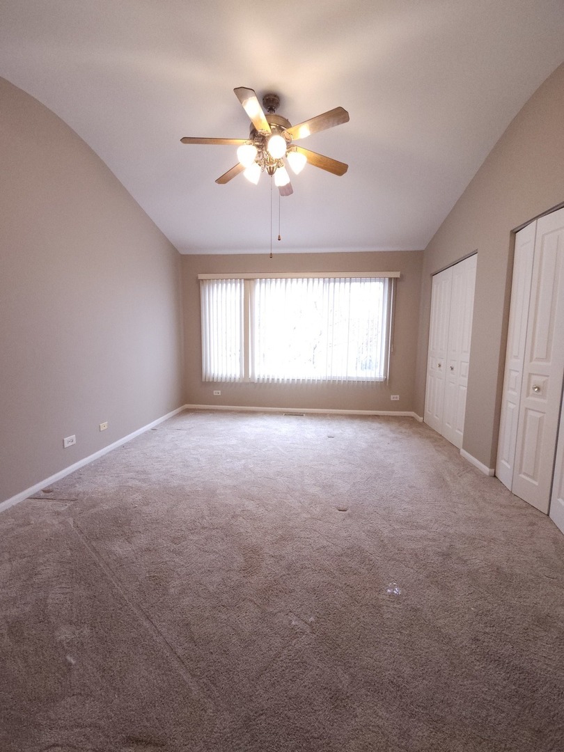 407 Spaulding Road, Unit 407 Bartlett, IL 60103 - Photo 9 of 18 a view of a livingroom with a chandelier fan and windows