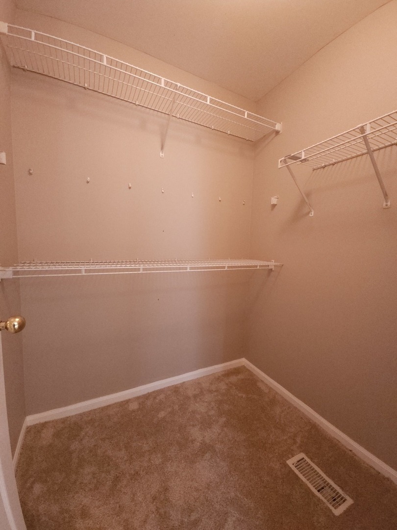 407 Spaulding Road, Unit 407 Bartlett, IL 60103 - Photo 10 of 18 a view of a room with racks on the wall