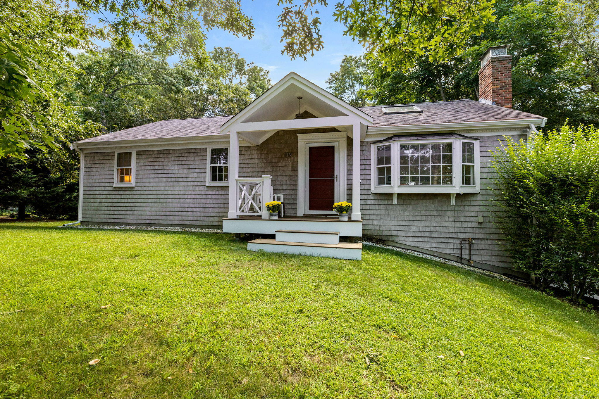 119 Cottonwood Road Harwich, MA 02645 - Photo 30 of 30 a front view of a house with a garden