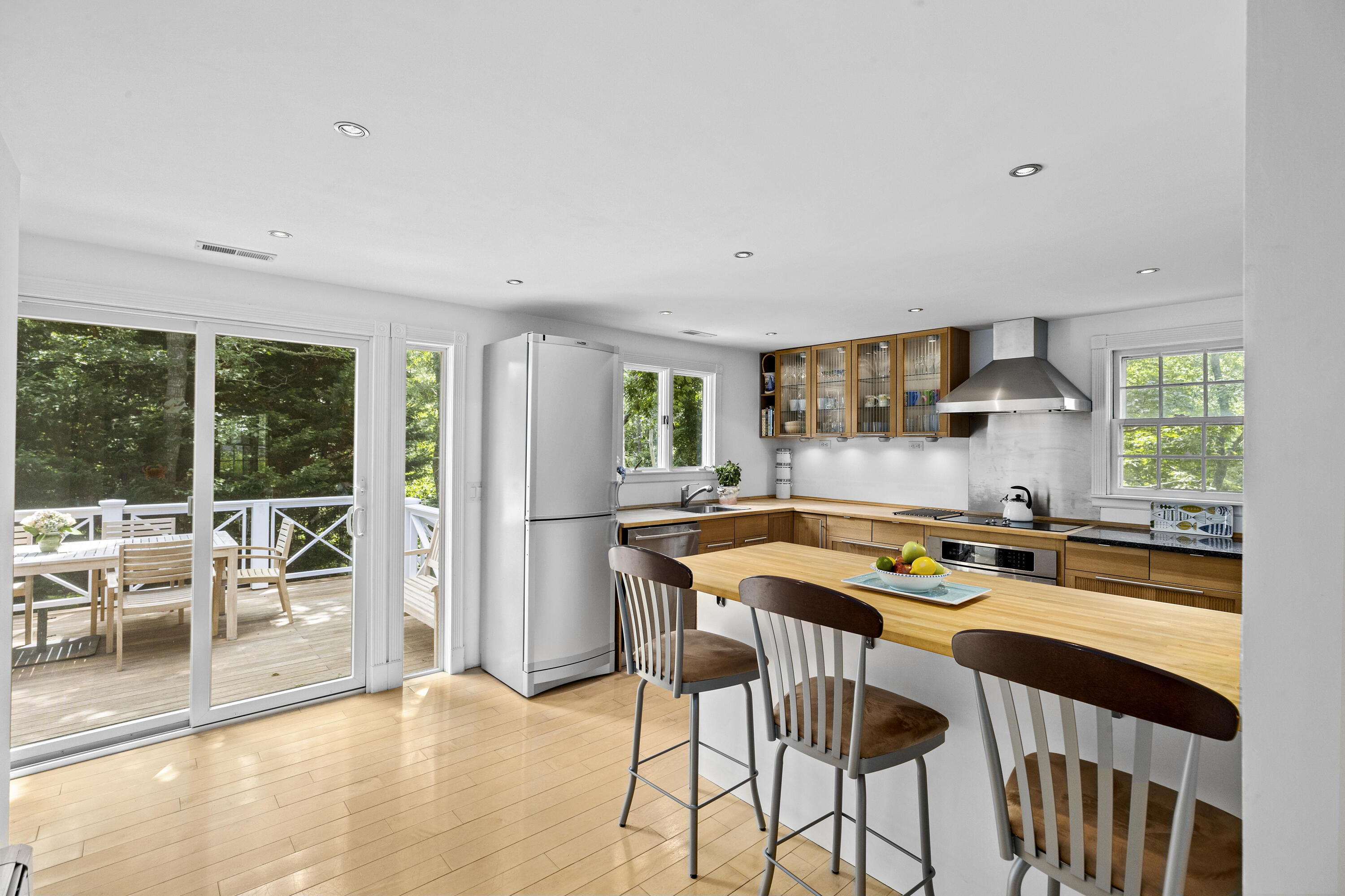 119 Cottonwood Road Harwich, MA 02645 - Photo 7 of 30 a kitchen with stainless steel appliances a table and chairs in it