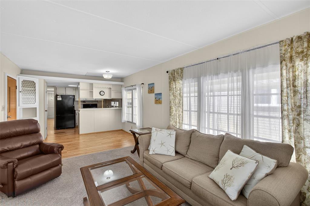 802 Turf Street Venice, FL 34285 - Photo 20 of 50 a living room with furniture and a large window with kitchen view