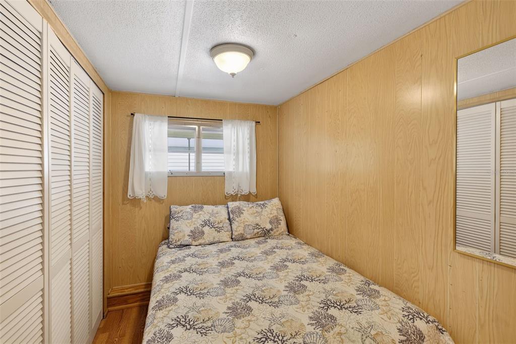 802 Turf Street Venice, FL 34285 - Photo 25 of 50 a bedroom with a bed and wooden floor