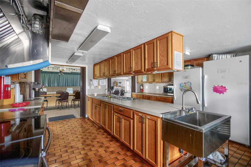 802 Turf Street Venice, FL 34285 - Photo 50 of 50 a kitchen with granite countertop lots of counter top space and wooden floor