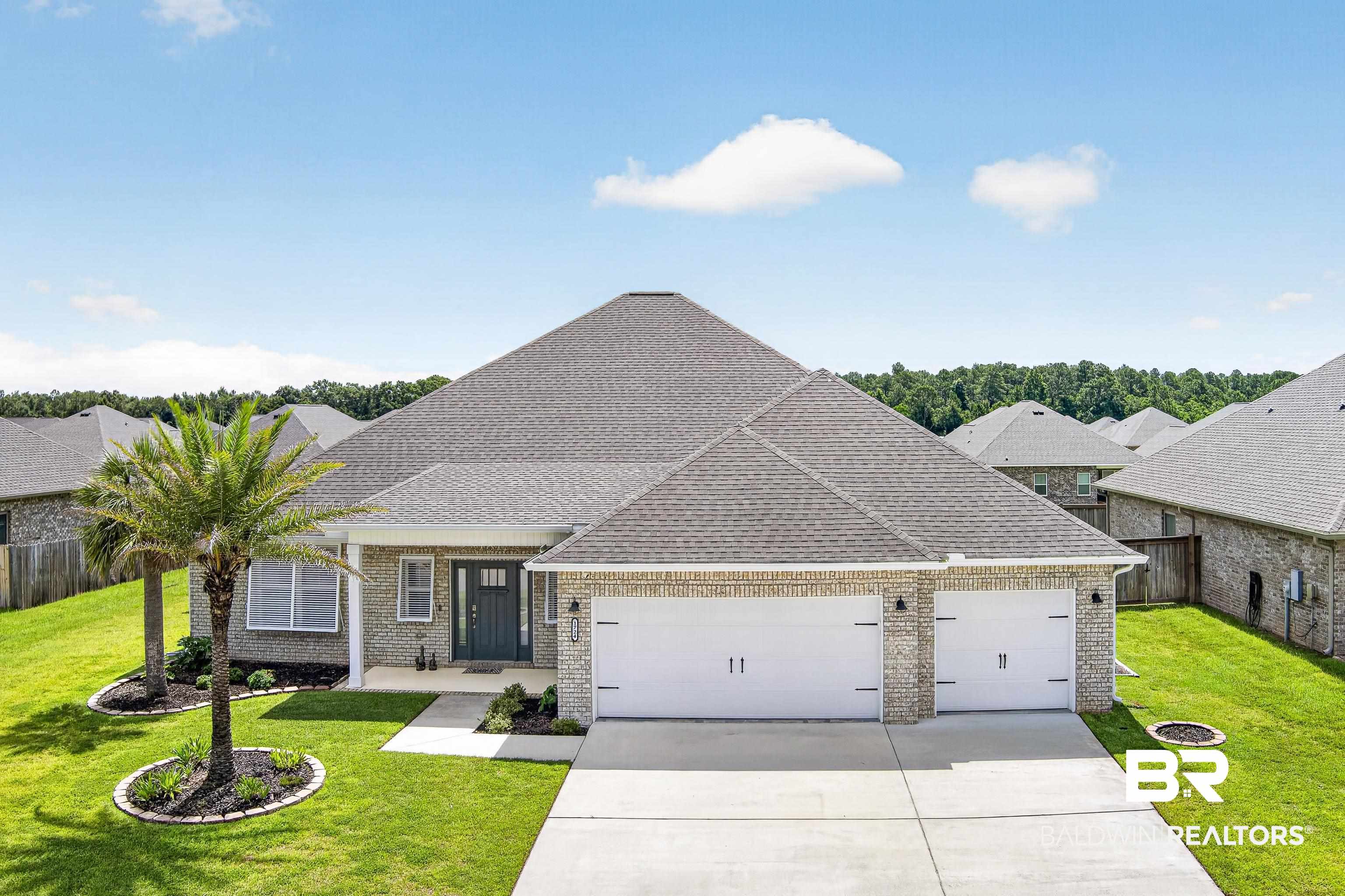 1724 Partridge Street Foley, AL 36535 - Photo 1 of 62 Brick exterior residence featuring a prominent two-car garage with white paneled doors