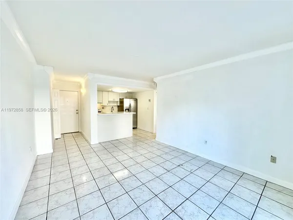 a view of a kitchen with white cabinets and refrigerator