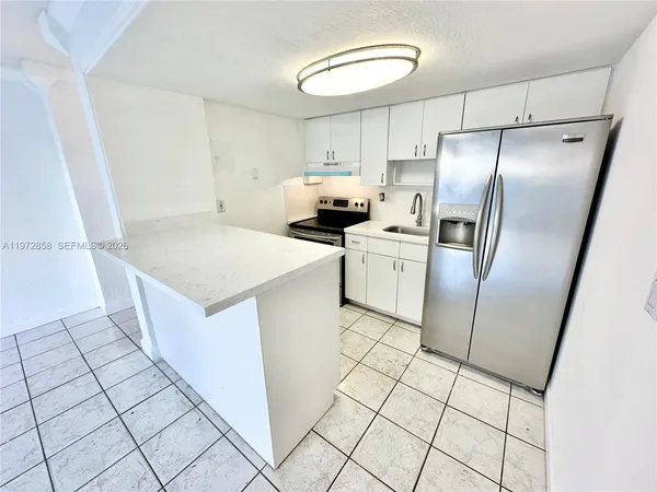 a kitchen with cabinets and stainless steel appliances
