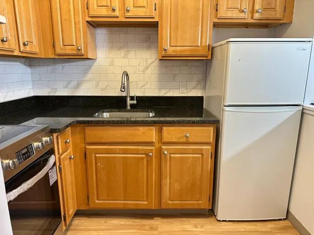 a white refrigerator freezer sitting inside of a kitchen
