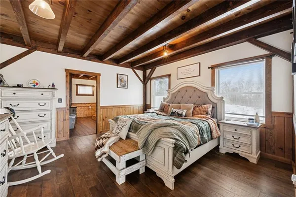 a spacious bedroom with a bed and a large window