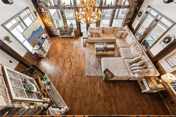 a living room with furniture a air conditioner vent and a rug