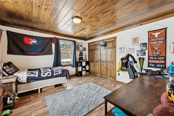 a bedroom with furniture and wooden floor