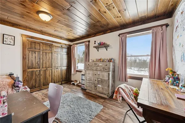 a bedroom with furniture and wooden floor