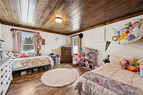 a bedroom with baby bed and a window