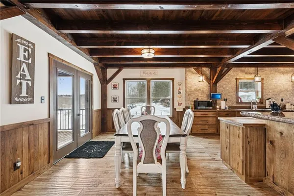 a view of a kitchen with table and chairs