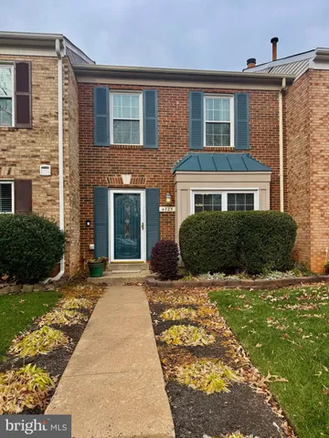 a front view of a house with yard and porch