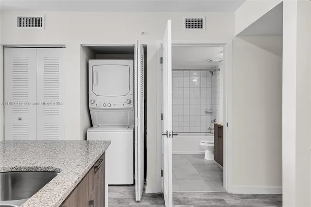 a kitchen with stainless steel appliances a refrigerator stove and sink