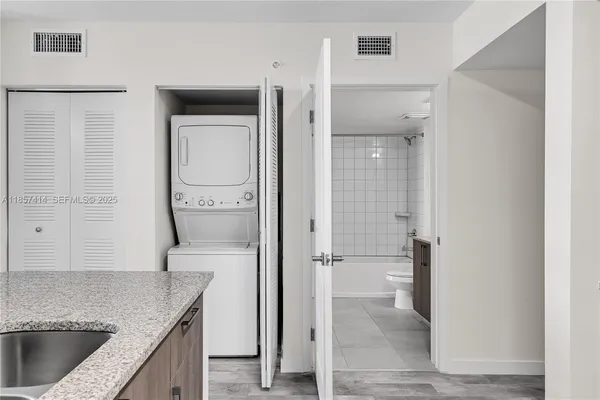 a kitchen with stainless steel appliances a refrigerator stove and sink