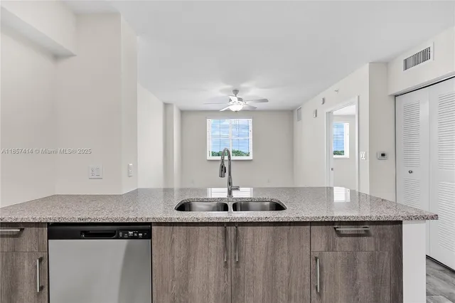 a bathroom with a granite countertop double vanity sink and mirror