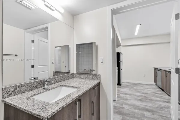 a kitchen with granite countertop a sink and stainless steel appliances