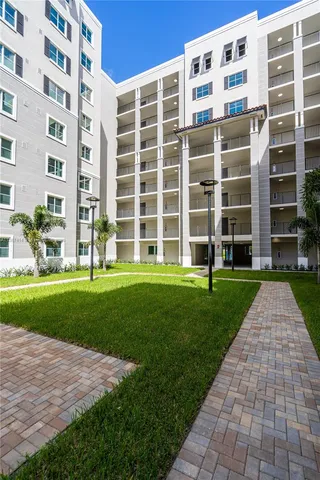 a view of a building with a yard