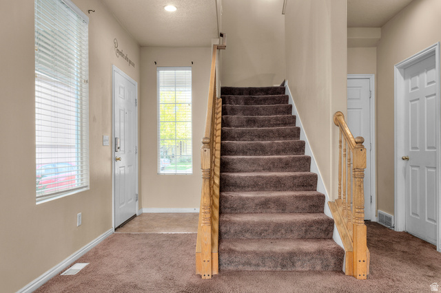 3053 Sage Loop, Unit B1 Lehi, UT 84043 - Photo 5 of 25 Entryway featuring carpeted flooring and a wood baluster staircase