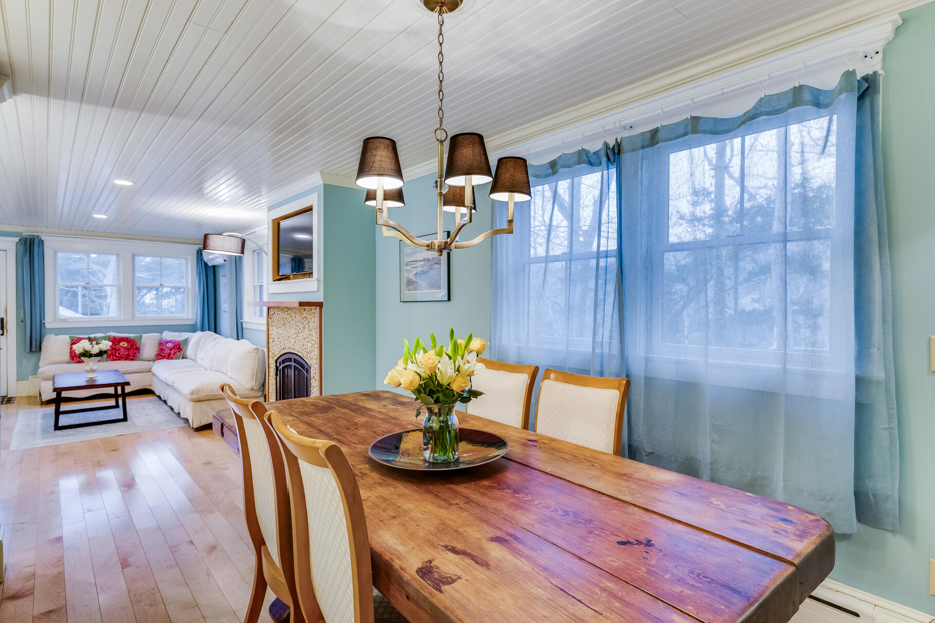 117 Gardiner Road Woods Hole, MA 02543 - Photo 13 of 81 a view of a dining room with furniture a chandelier and wooden floor
