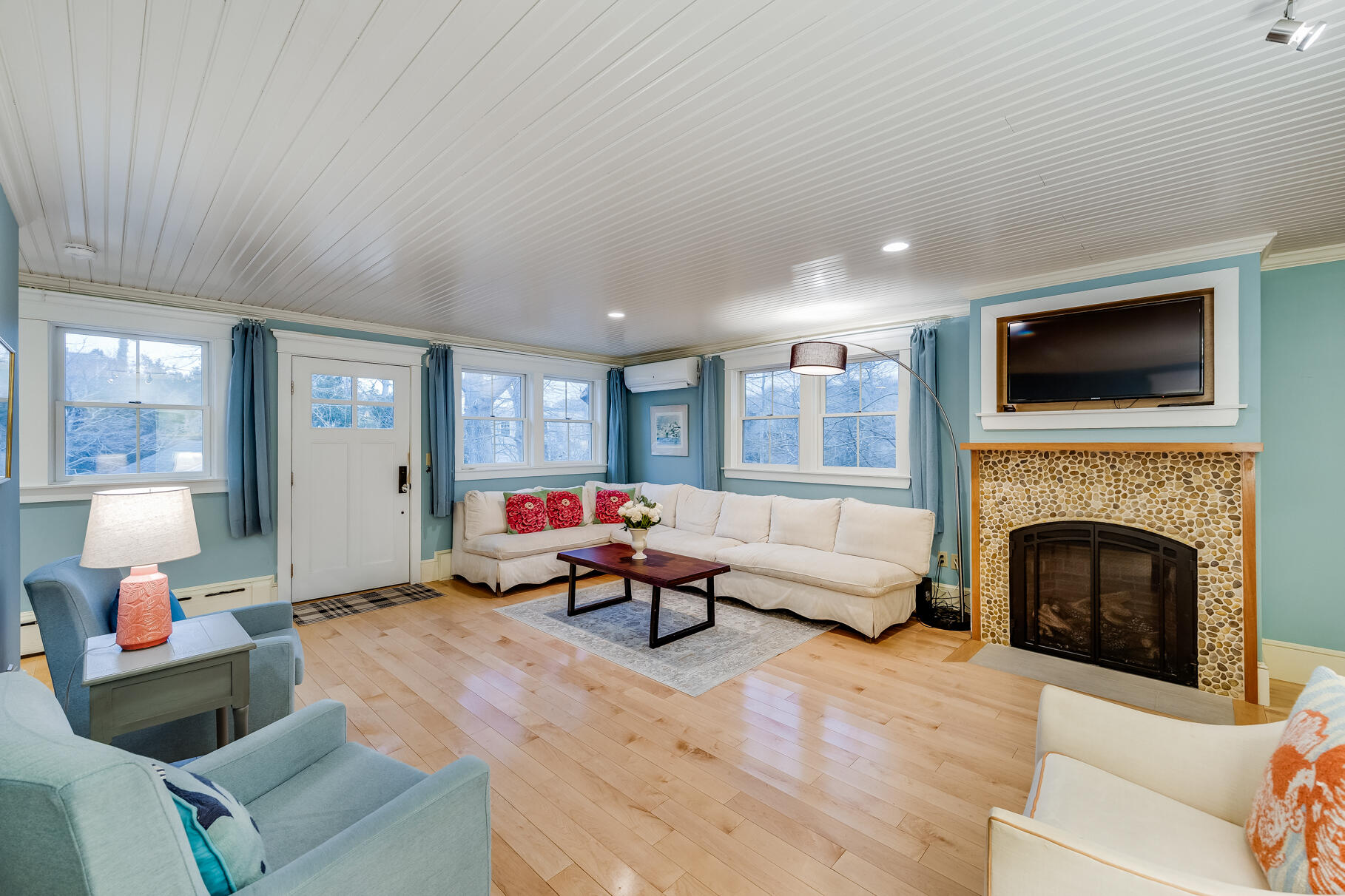 117 Gardiner Road Woods Hole, MA 02543 - Photo 8 of 81 a living room with furniture a fireplace and a flat screen tv