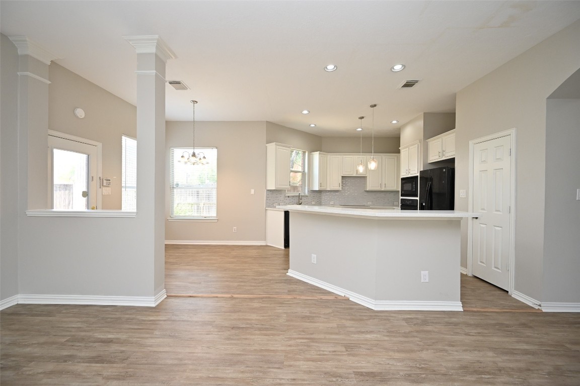 1502 Beaconshire Houston, TX 77077 - Photo 13 of 29 a view of kitchen with kitchen island a sink wooden floor and a refrigerator