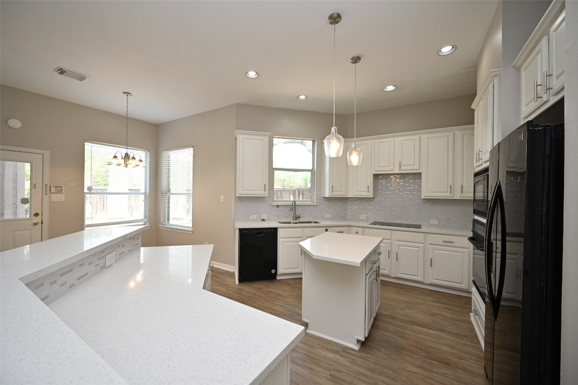 1502 Beaconshire Houston, TX 77077 - Photo 14 of 29 a large kitchen with kitchen island a sink a center island stainless steel appliances and a window