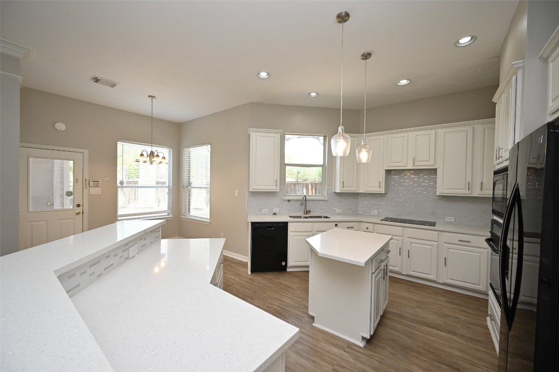 1502 Beaconshire Houston, TX 77077 - Photo 18 of 29 a large white kitchen with kitchen island a sink a center island stainless steel appliances and a cabinets