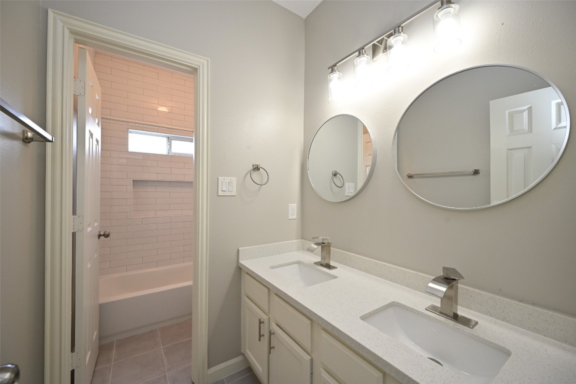 1502 Beaconshire Houston, TX 77077 - Photo 19 of 29 a bathroom with a double vanity sink mirror and shower