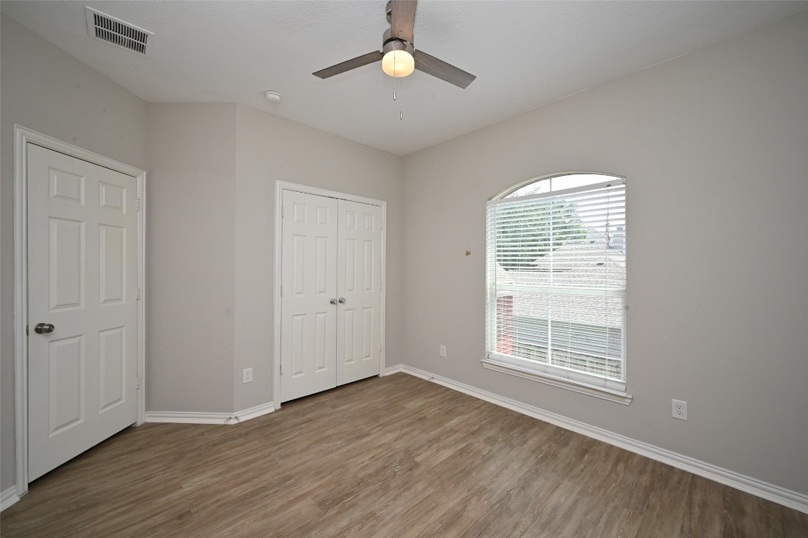 1502 Beaconshire Houston, TX 77077 - Photo 20 of 29 wooden floor in an empty room with a window
