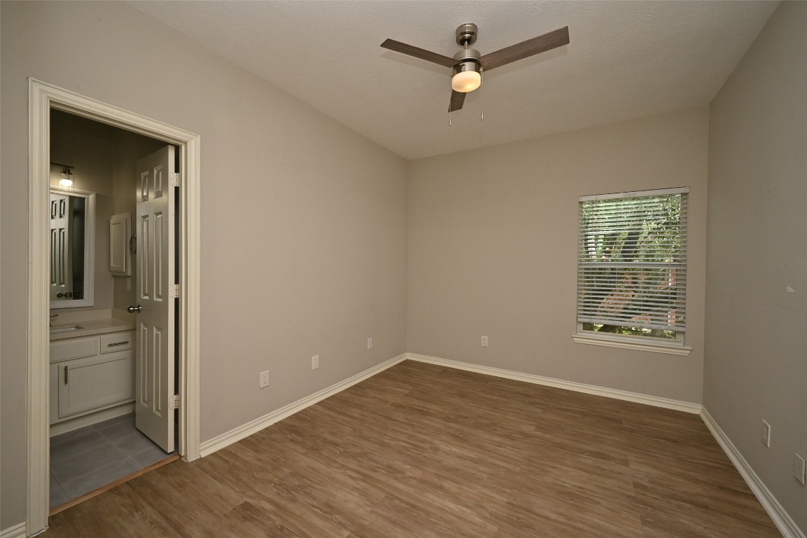 1502 Beaconshire Houston, TX 77077 - Photo 22 of 29 wooden floor in an empty room with a window