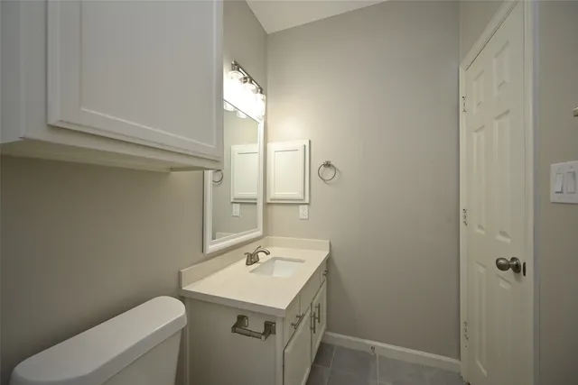 a bathroom with a sink toilet and mirror