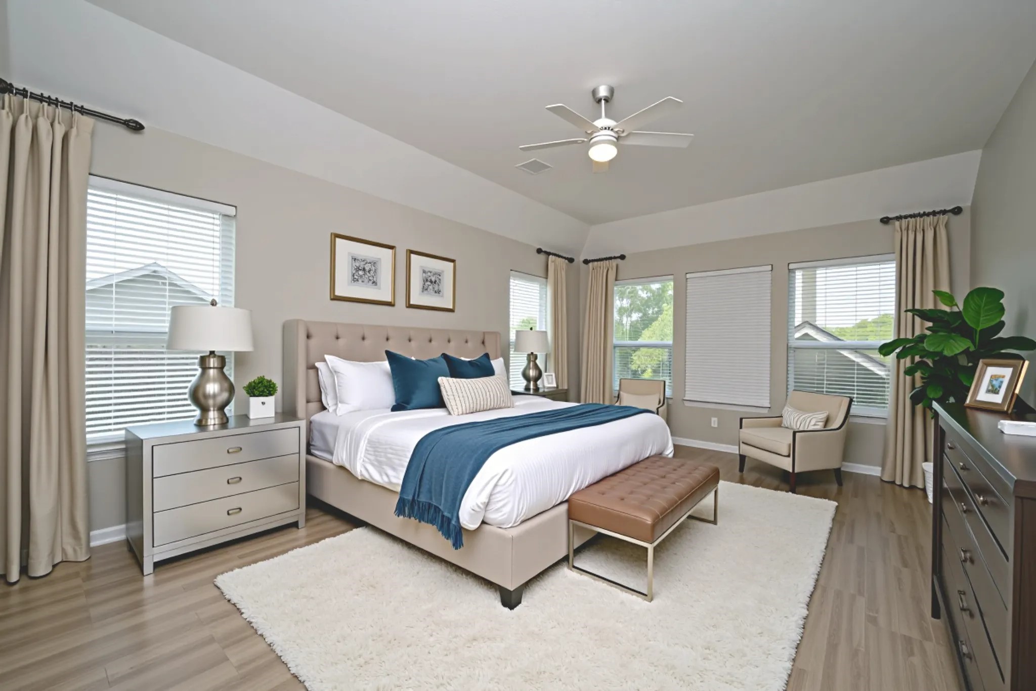 1502 Beaconshire Houston, TX 77077 - Photo 25 of 29 a spacious bedroom with a large bed and a chandelier
