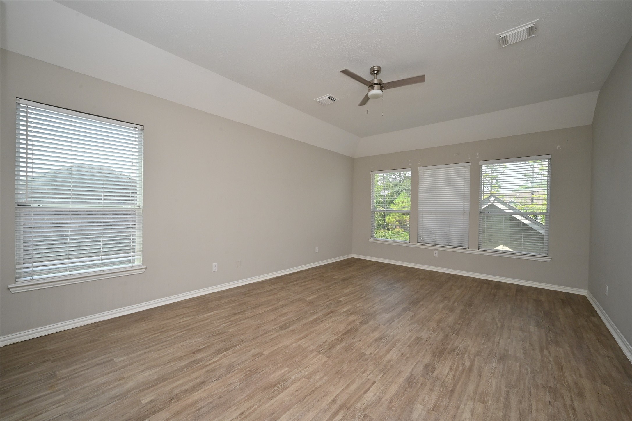1502 Beaconshire Houston, TX 77077 - Photo 26 of 29 an empty room with wooden floor and windows
