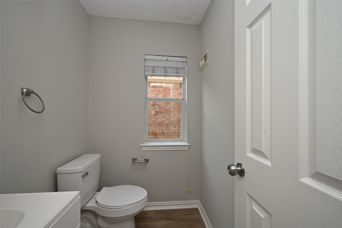 1502 Beaconshire Houston, TX 77077 - Photo 8 of 29 a white toilet sitting next to a bathroom sink