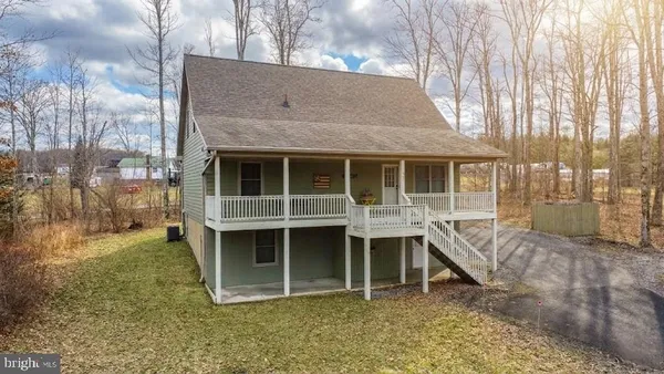 a view of a house with a yard and deck