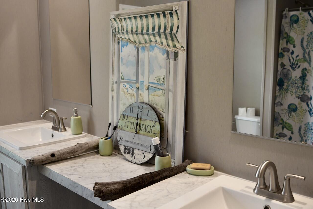 1430 Nixonton Road Elizabeth City, NC 27909 - Photo 24 of 30 Bathroom #2 offers a large vanity area with 2 tall inks, 2 large individual mirrors with storage space underneath.