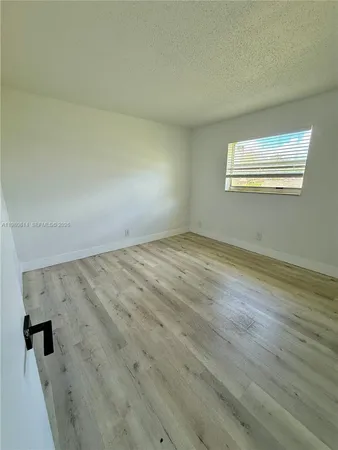 an empty room with wooden floor