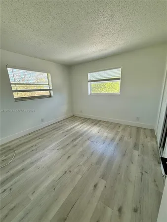 a view of an empty room and wooden floor
