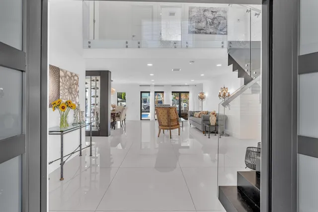 a living room with furniture and kitchen view