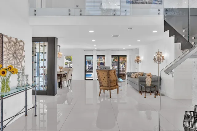 a living room with furniture and a dining table with kitchen view