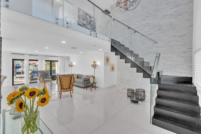 a living room with stainless steel appliances kitchen island granite countertop furniture and a view of living room