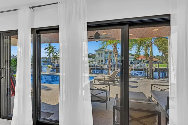 a view of a patio with a table and chairs under an umbrella