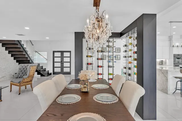 a view of a dinning table and chairs in patio of a house