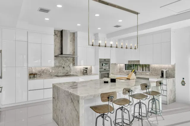 a view of a balcony with dining table and chairs